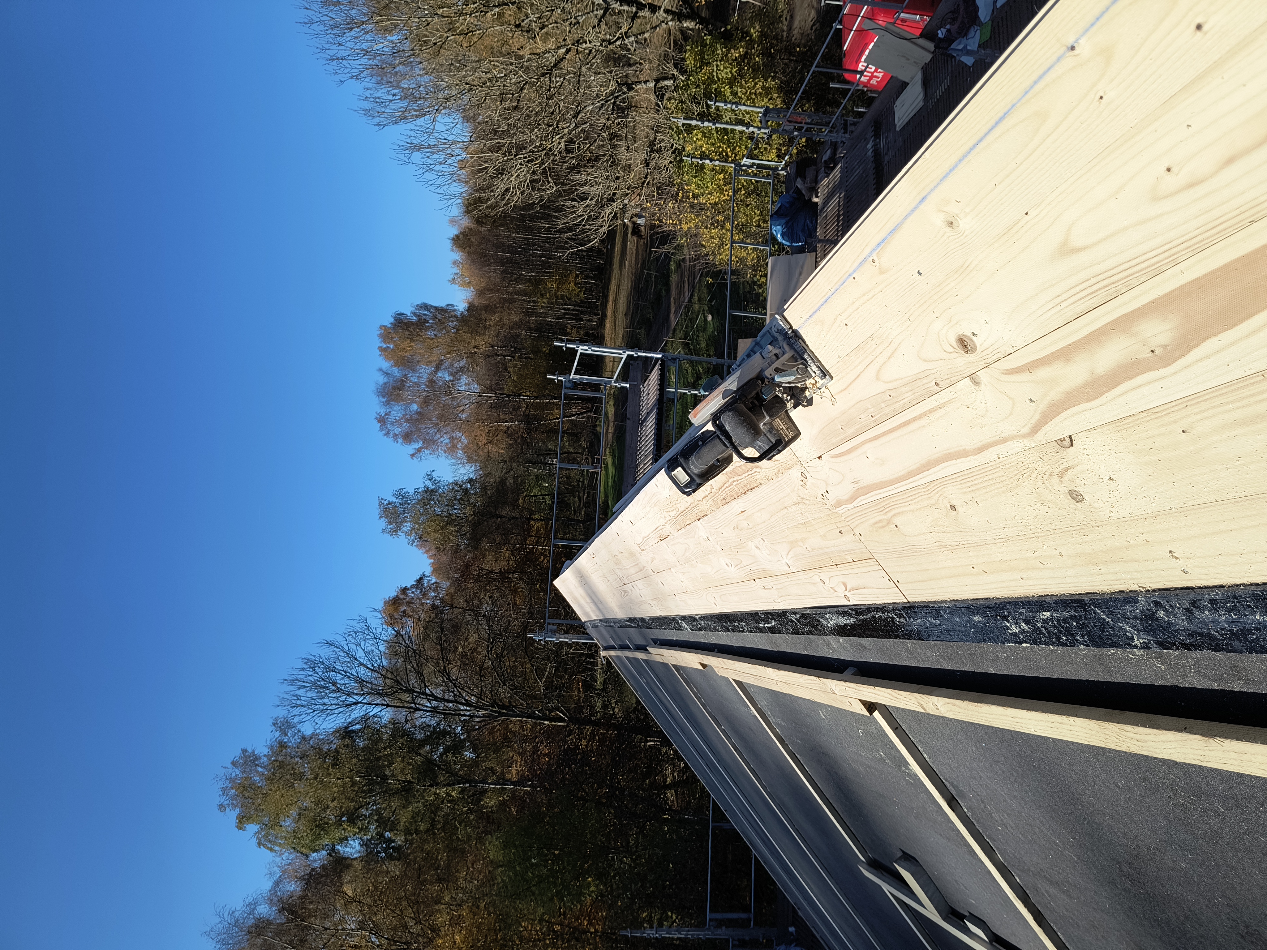 Takomläggning på en villa där nytt, tätt underlag med råspont och takpapp är lagt. Taket är nu förberett för montering av ett nytt tak.